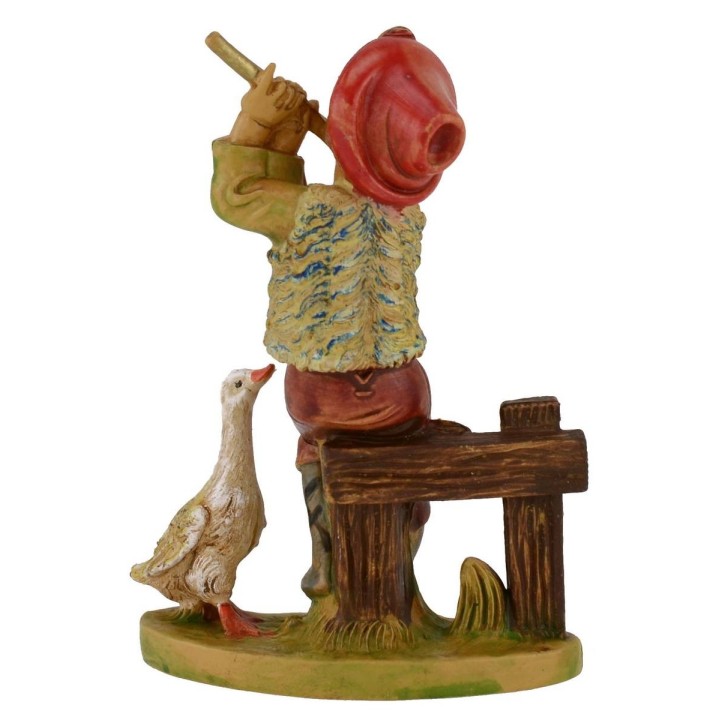 Niño sentado con flauta en pvc lux serie 12 cm