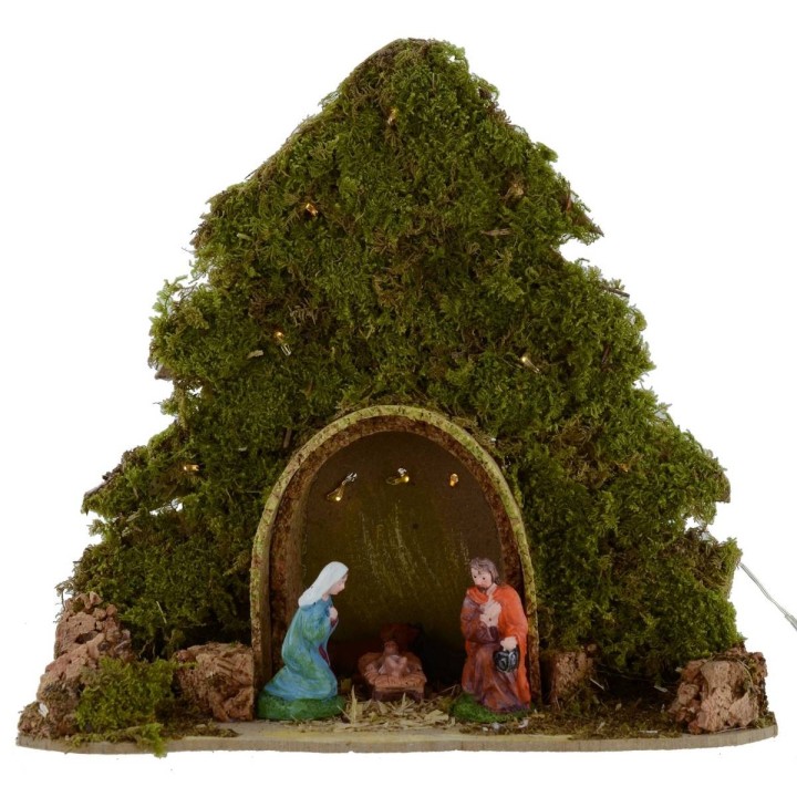 Tree with hut and Nativity illuminated with piled with