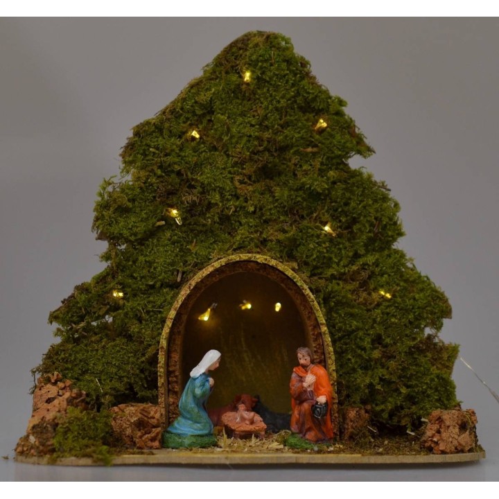 Tree with hut and Nativity illuminated with piled with