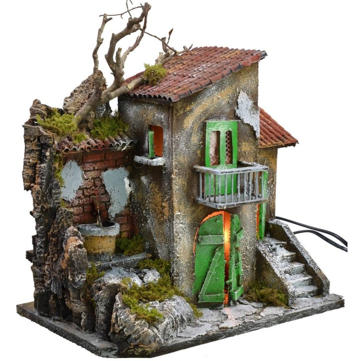 Casa iluminada con fuente funcionando de 30x21x35 cm h