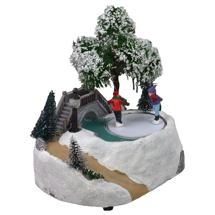 Christmas scenery with bridge and battery-operated skating rink