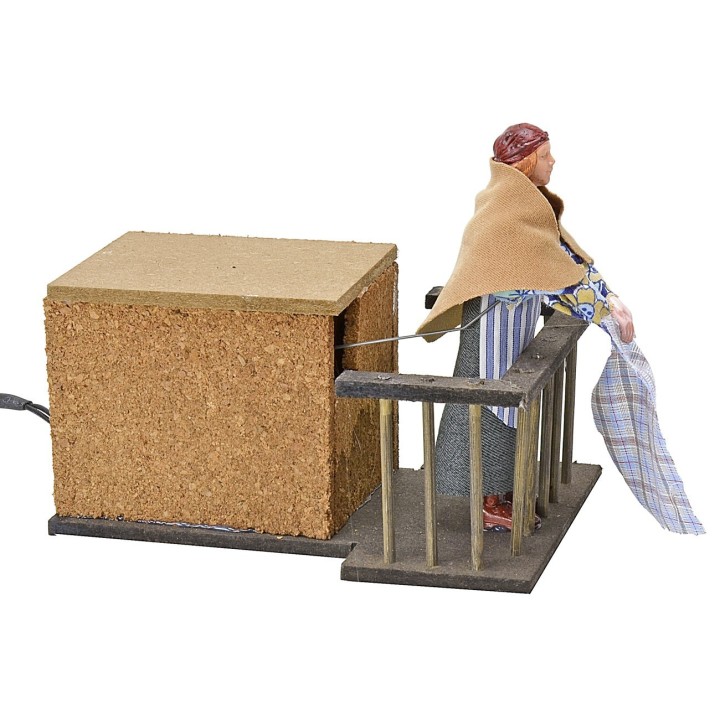 Woman 12 cm on the balcony flapping clothes in movement cm