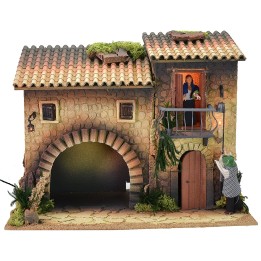 Casa illuminata con lampionaio 12 cm in movimento e donna che