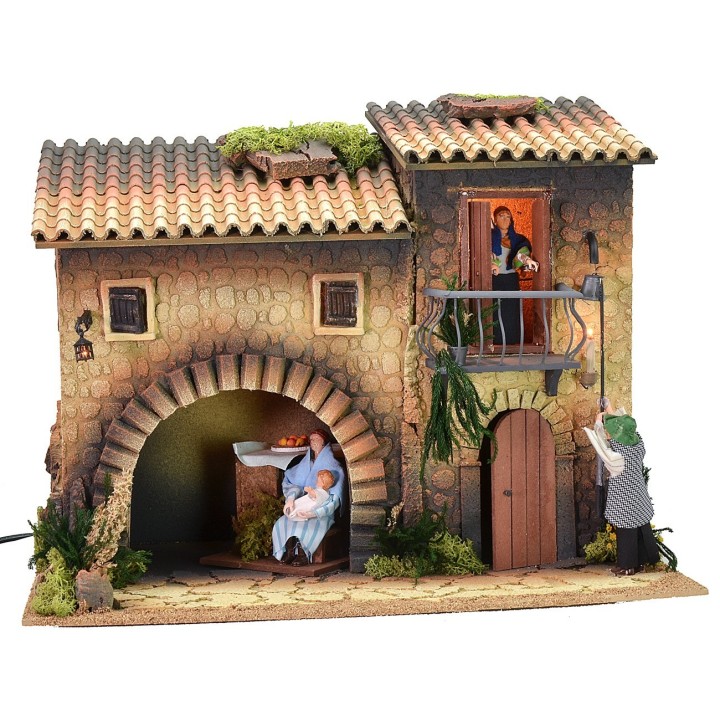 Casa illuminata con lampionaio 12 cm in movimento e donna che