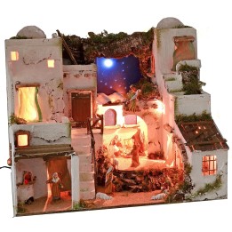 Pesebre árabe iluminado con cielo estrellado, horno y estatuas