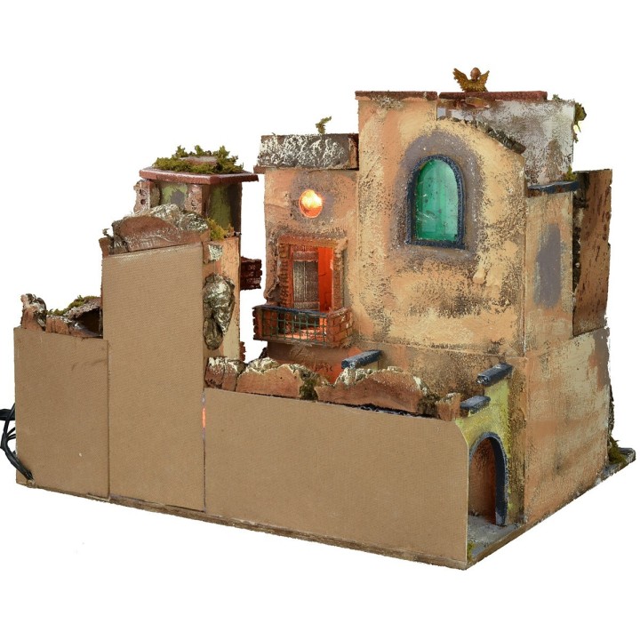Pesebre con pueblo iluminado, horno y fuente funcionando de