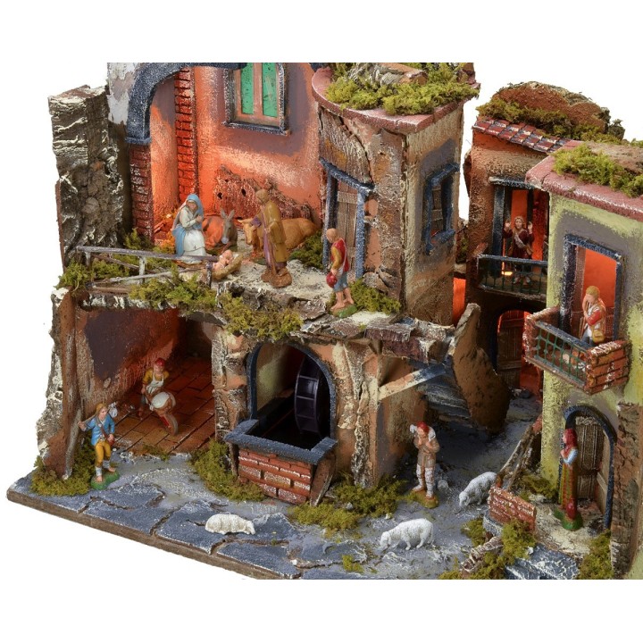 Pesebre completo con estatuas, pueblo iluminado, horno y fuente