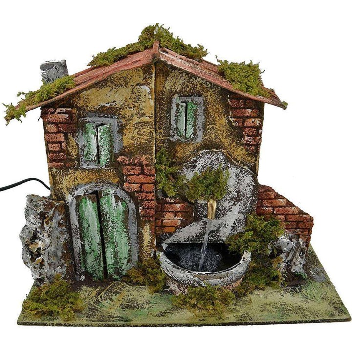 Casa belén con fuente de 33x18x25 cm de altura.