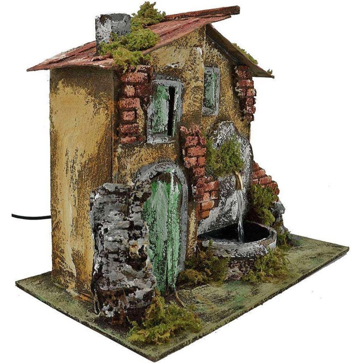Casa belén con fuente de 33x18x25 cm de altura.