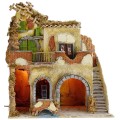 Pueblo iluminado con molino de agua y de viento en