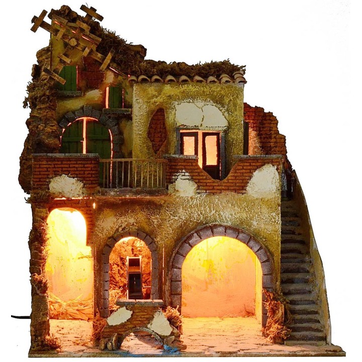 Pueblo iluminado con molino de agua y de viento en