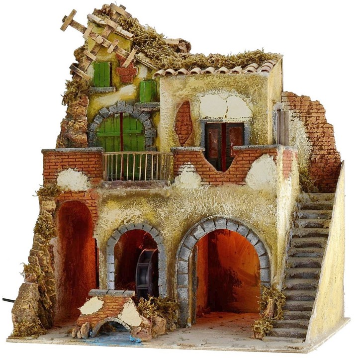 Pueblo iluminado con molino de agua y de viento en