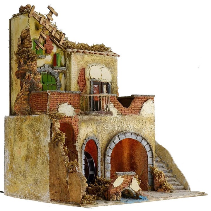 Pueblo iluminado con molino de agua y de viento en