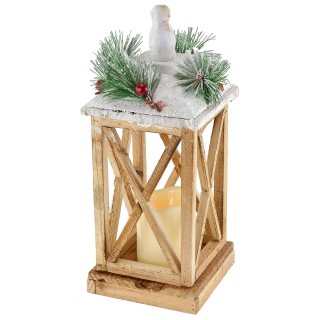 Snow-covered wooden lantern with battery-powered candle