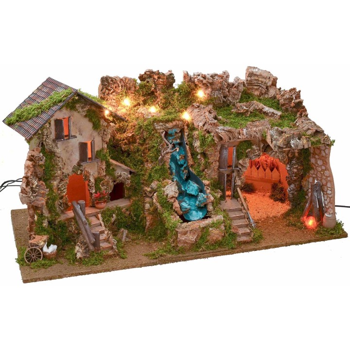 Illuminated nativity scene with cave, waterfall and fire