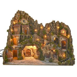 Illuminated nativity scene with cave, fountain, waterfall and