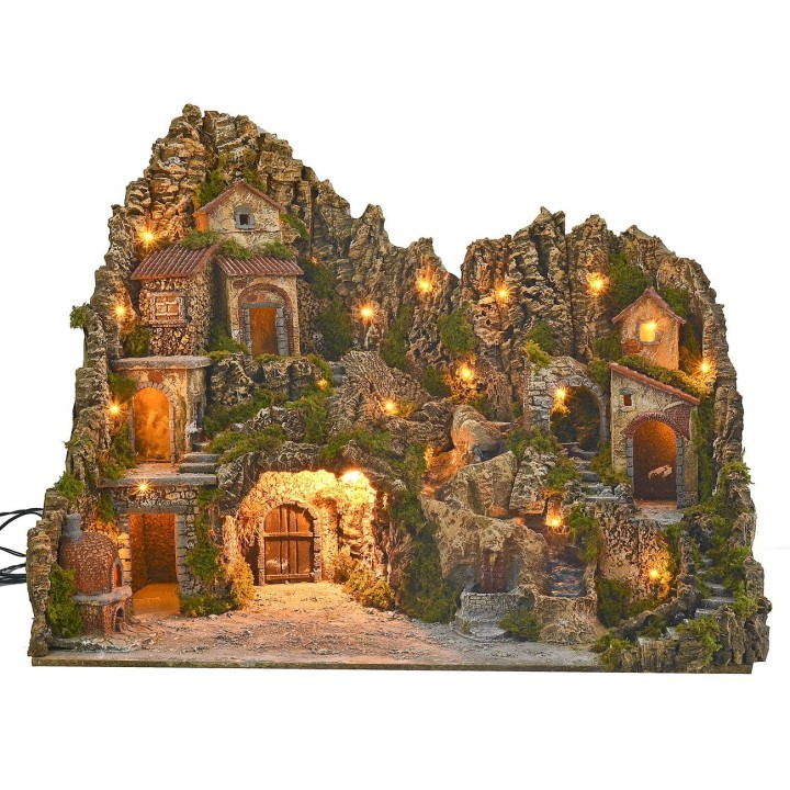 Illuminated nativity scene with cave, fountain, waterfall and