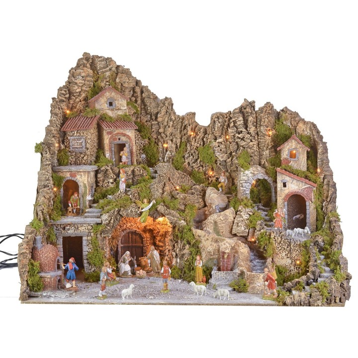 Illuminated nativity scene with a grotto, fountain, waterfall