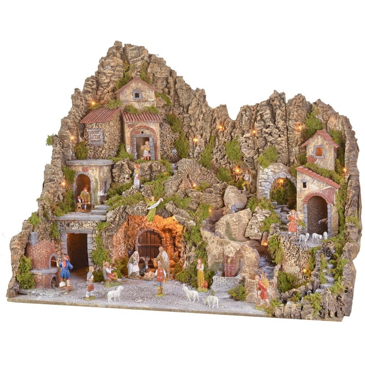Illuminated nativity scene with a grotto, fountain, waterfall