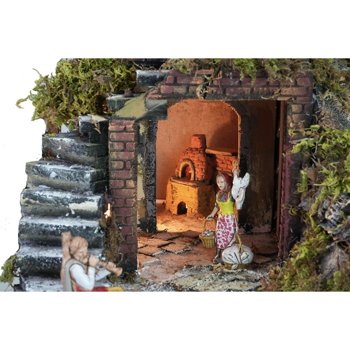 Illuminated nativity scene complete with statues, waterfall
