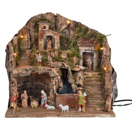 Illuminated nativity scene complete with waterfall and statues