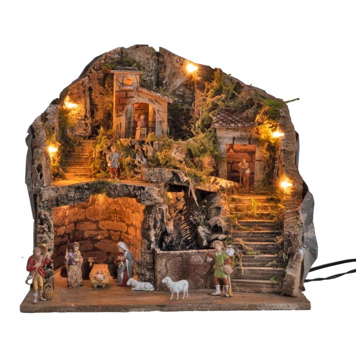 Illuminated nativity scene complete with waterfall and statues