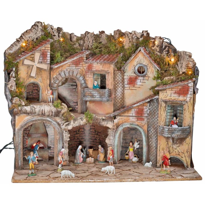 Illuminated nativity scene with arches, oven, mill, and
