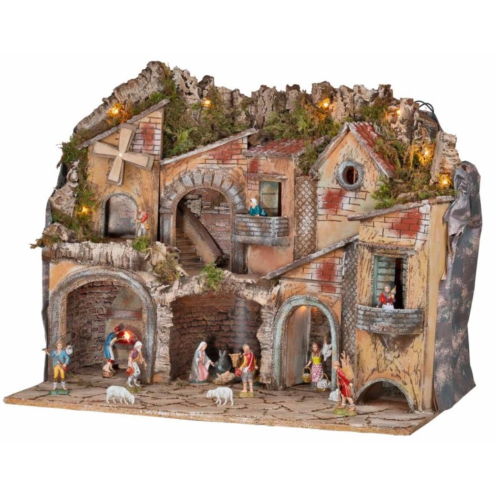 Illuminated nativity scene with arches, oven, mill, and