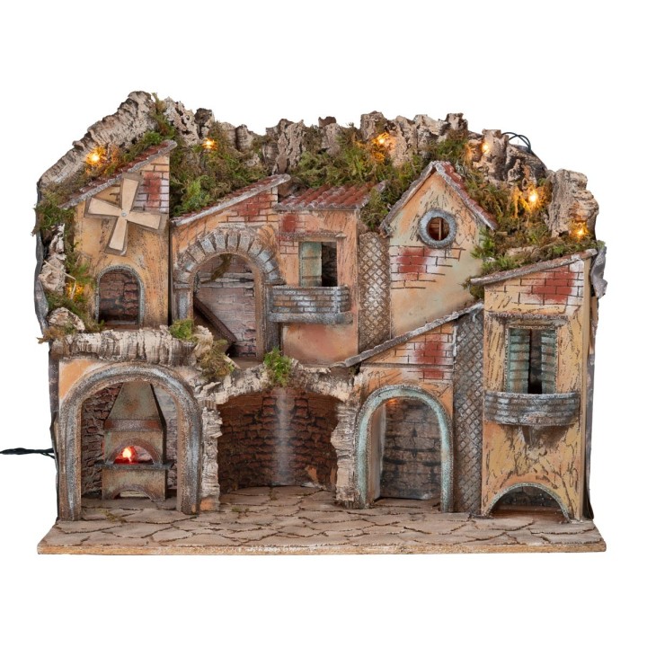 Illuminated nativity scene with arches, oven, mill, and