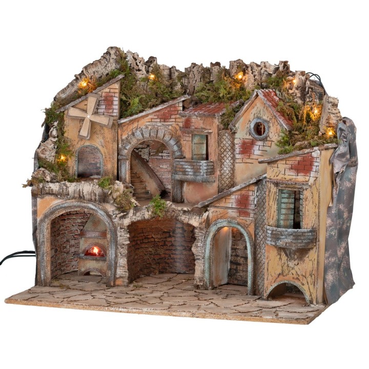 Illuminated nativity scene with arches, oven, mill, and