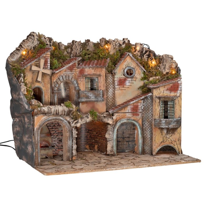 Illuminated nativity scene with arches, oven, mill, and
