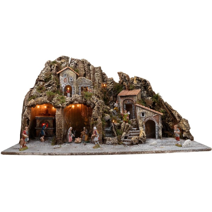 Illuminated nativity scene with oven and small waterfall