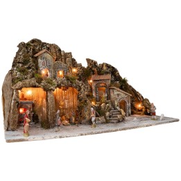 Illuminated nativity scene with oven and small waterfall