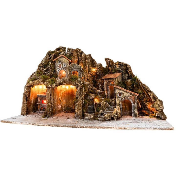 Illuminated nativity scene with oven and small waterfall