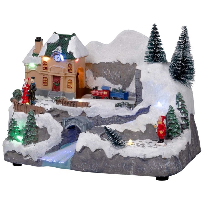 Christmas village with moving train equipped with lights and