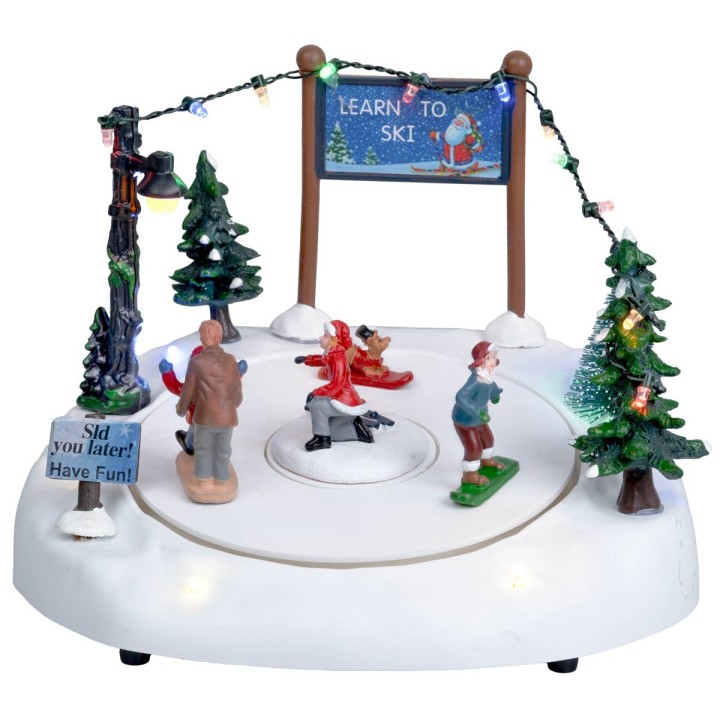 Ice rink with moving skiers complete with lights and music