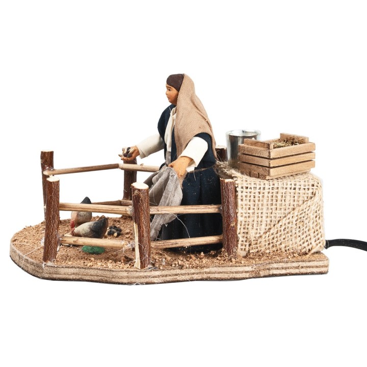 Donna che da becchime a galline cm 10 in movimento