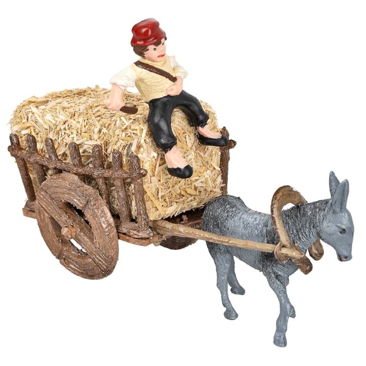 Man on donkey carrying cart loaded with hay