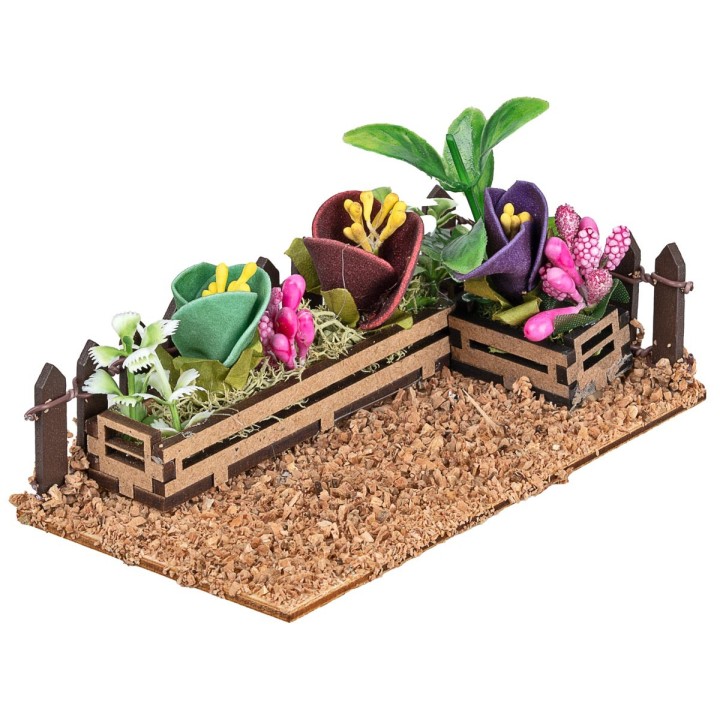 Fenced small garden with assorted flowers and plants cm