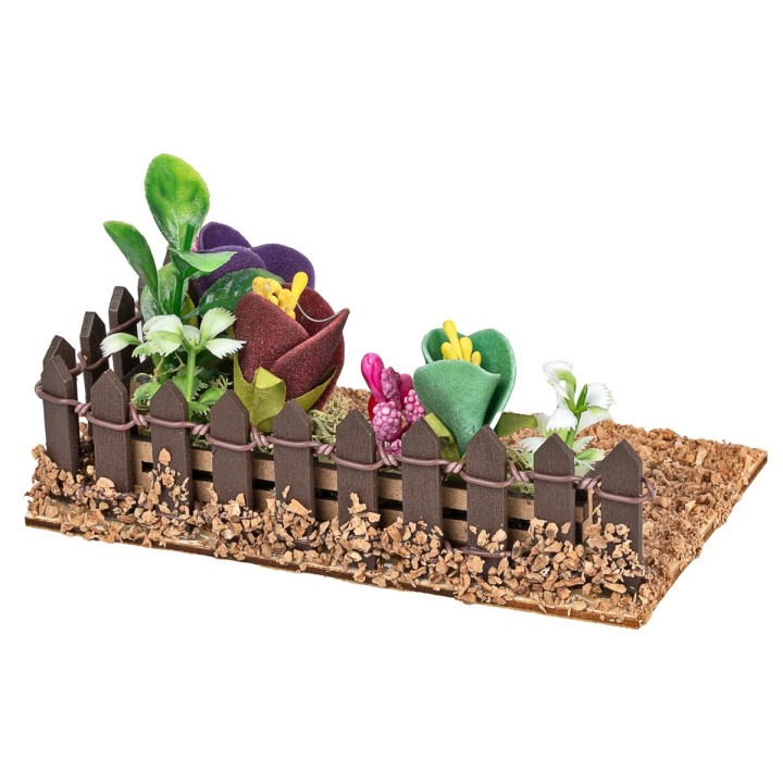 Fenced small garden with assorted flowers and plants cm