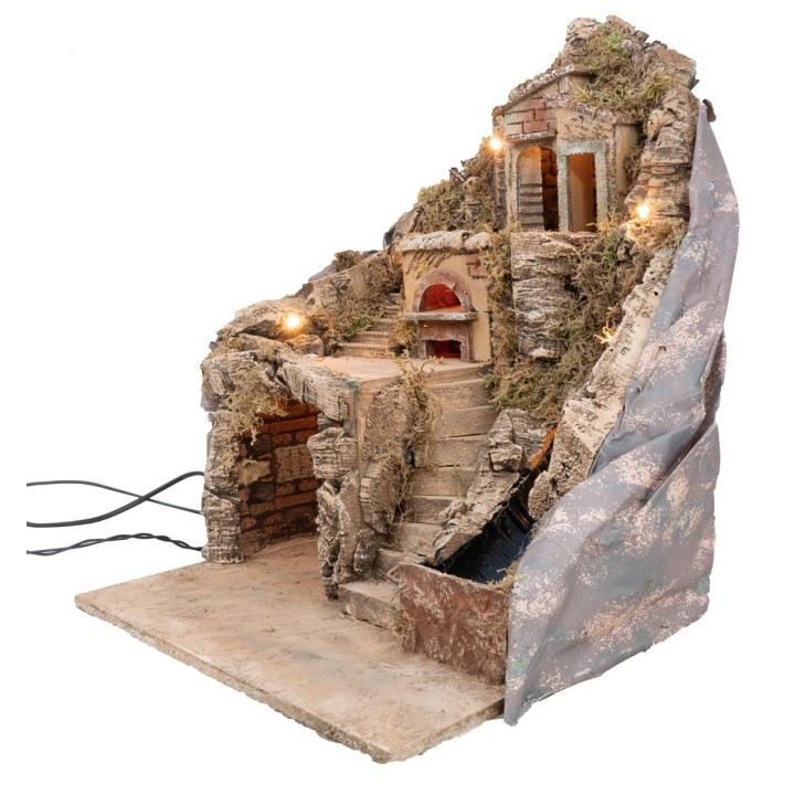 Illuminated nativity scene with oven and stream powered by